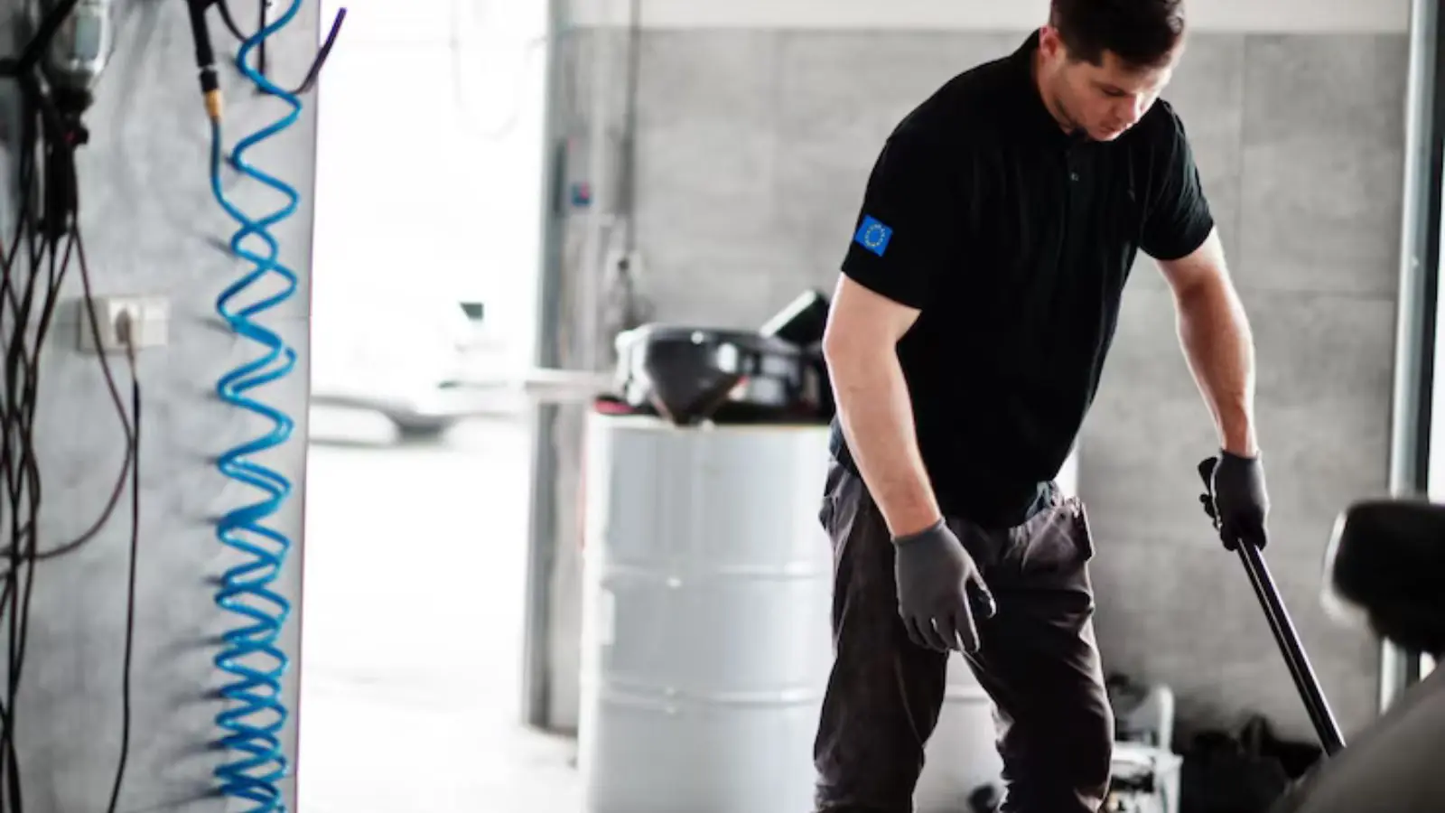 Technician with a pump unit on a wet floor in a home